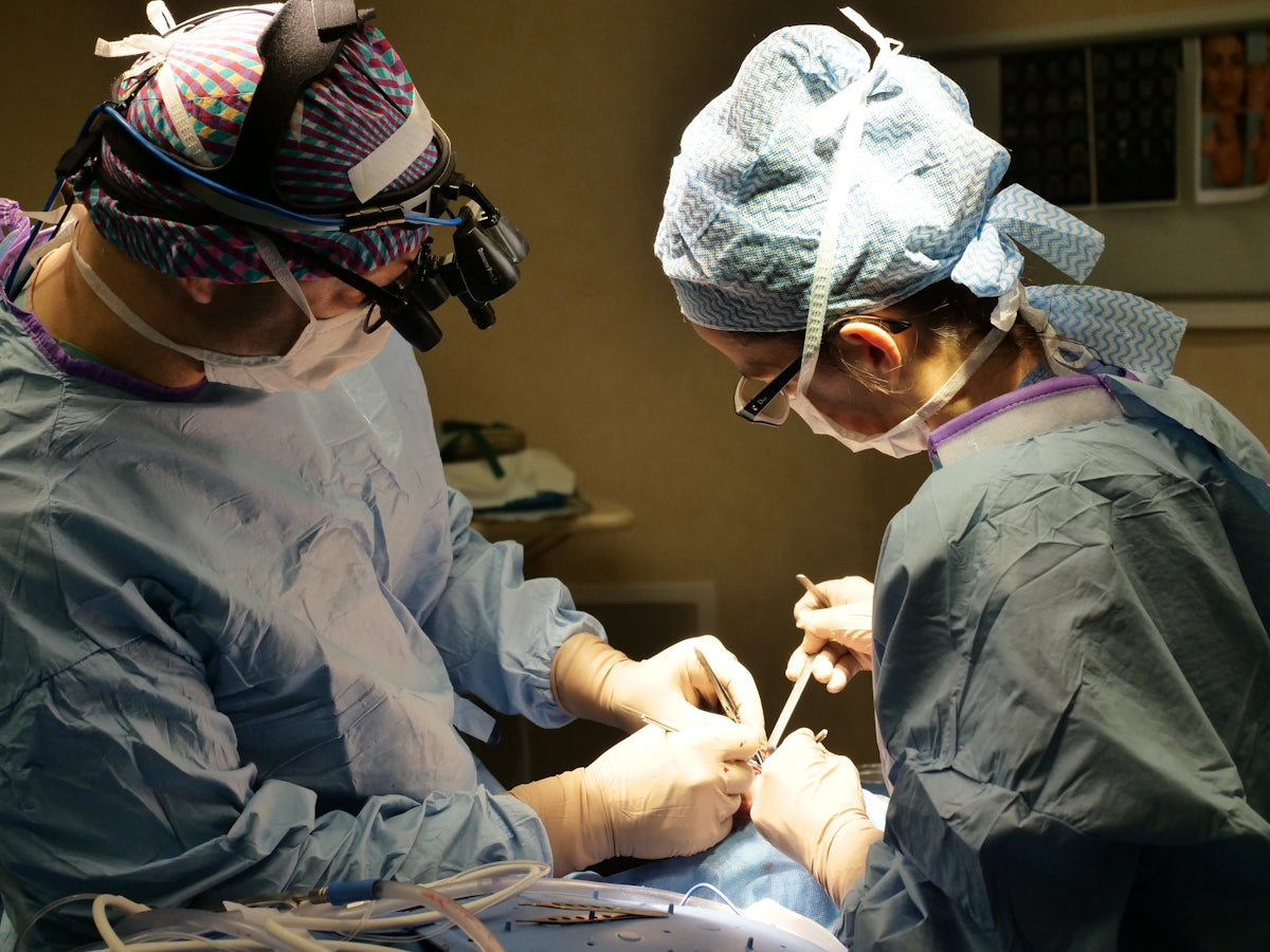 Surgeons performing a medical procedure in an operating room.